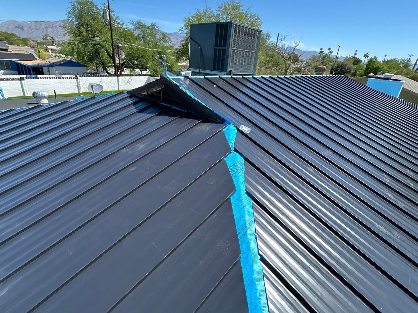 Black standing-seam metal roof on an Arizona home